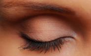 Woman's eye with long eyelashes and shaped eyebrow